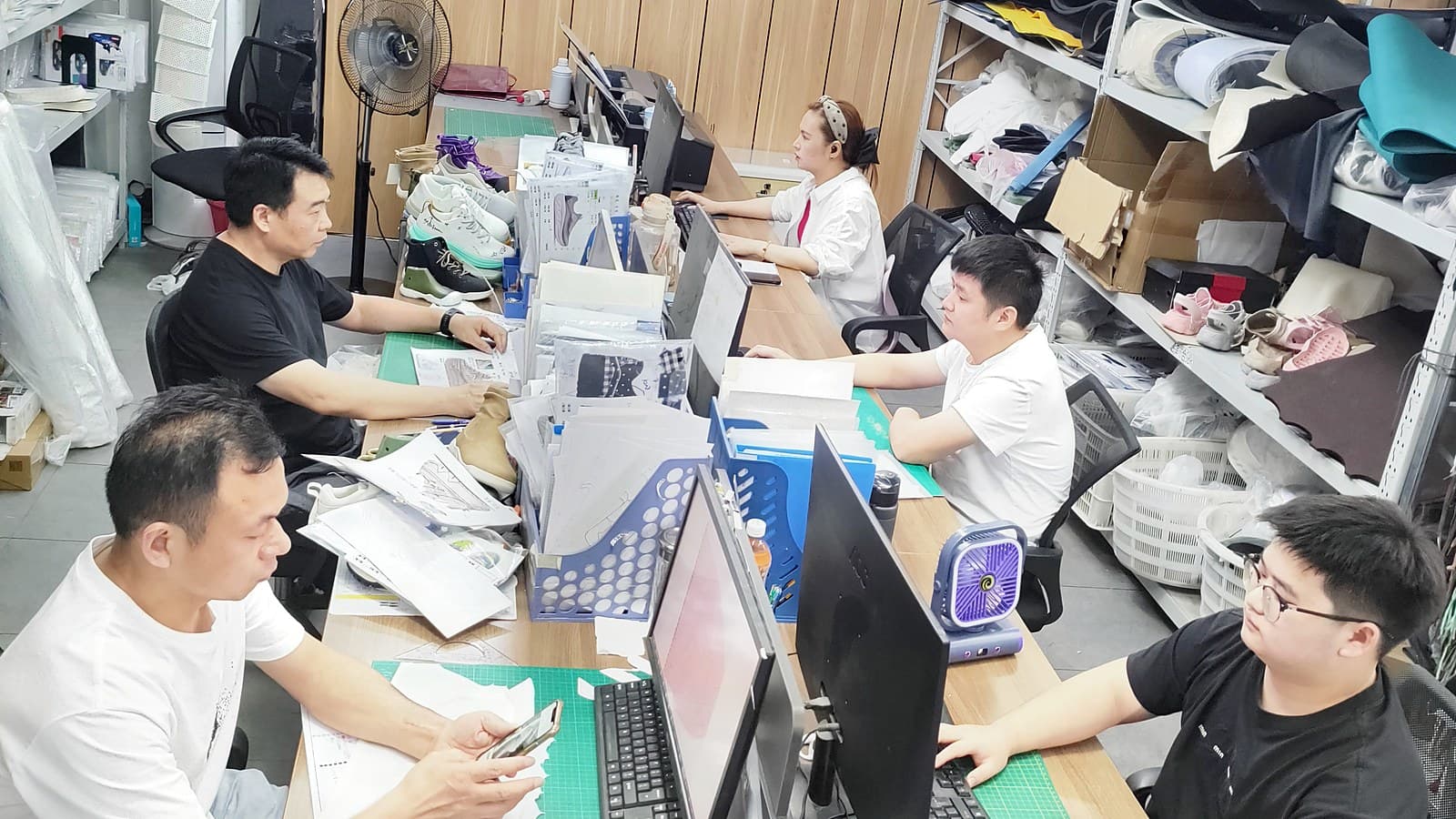 Footwear development team working with samples and project materials